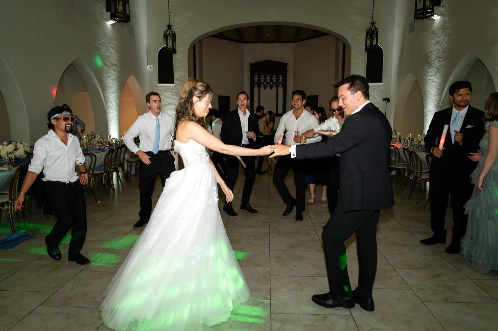 The couple dancing with friends on a lit-up dance floor at night